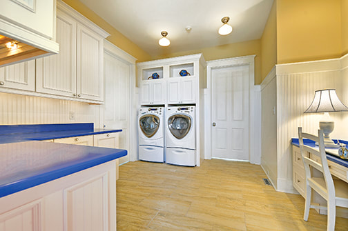 Laundry room design with counters and a desk for crafting
