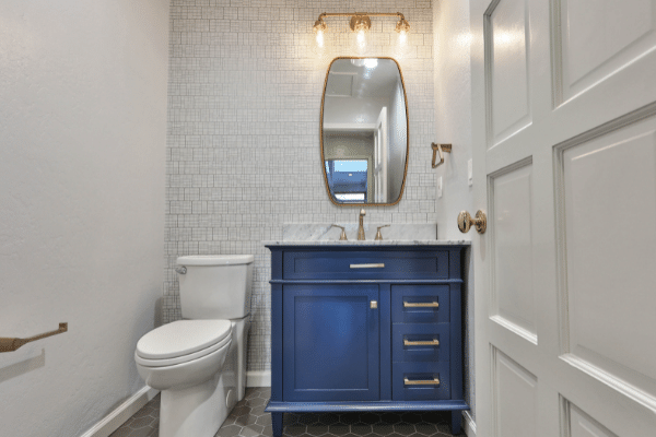 Transitional Hall Bath with Blue Vanity and Champagne Brass Fixtures