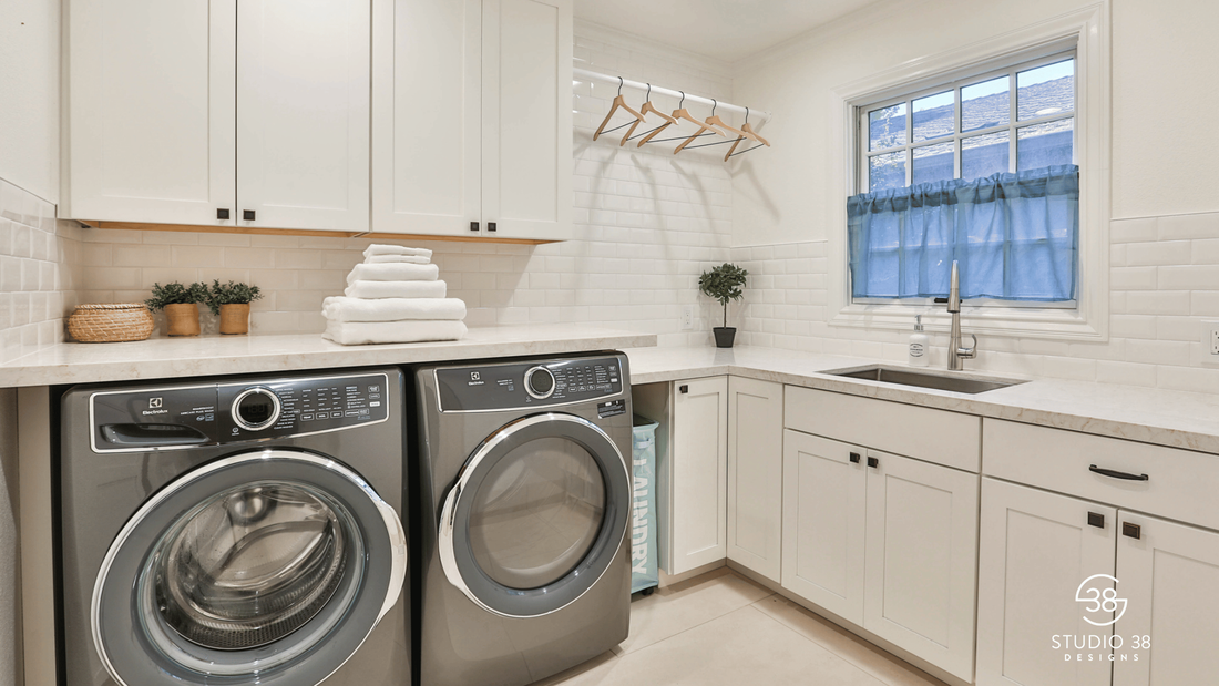 White and bright laundry room design with white subway tile