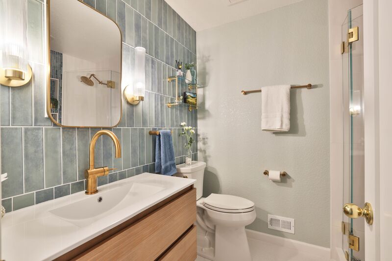 rectangular bathroom tile on sink wall with mirror reflecting shower head 