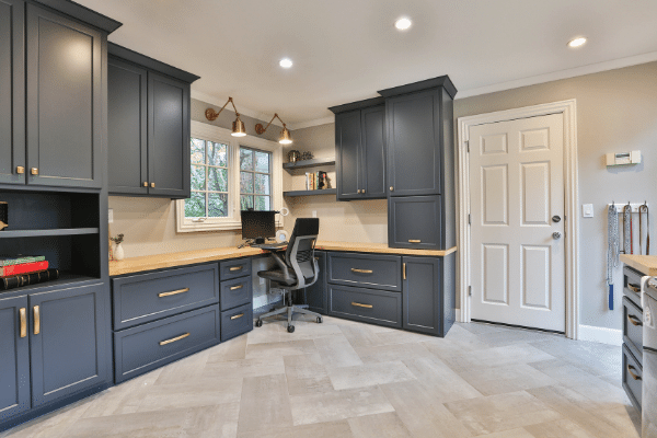 tiled floor office with blue cabinets and tan countertops.