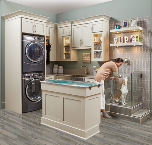 Laundry room design with a pet wash area and doggo getting a bath