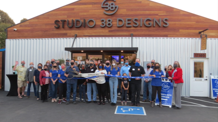 Ribbon cutting ceremony in front of the Studio 38 Designs building
