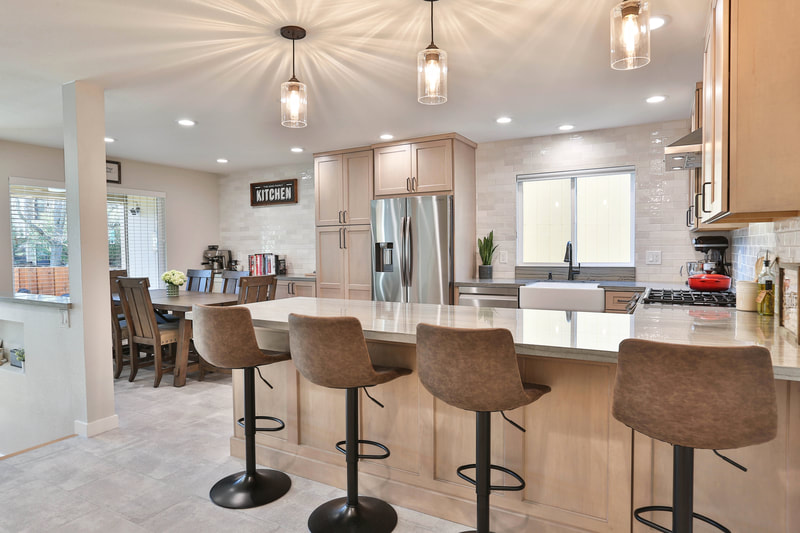 bar table kitchen with brown stools and white cabinets 