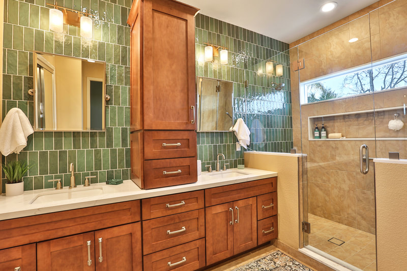 Stained wood cabinets in an upside-down T shape. with different shades of green, rectangle, vertical, backsplash tile 